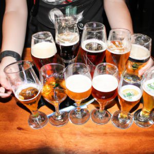 Person holding various beer glasses