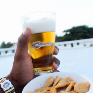 Person holding beer and food