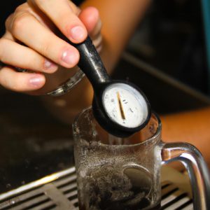 Person holding beer thermometer, pouring